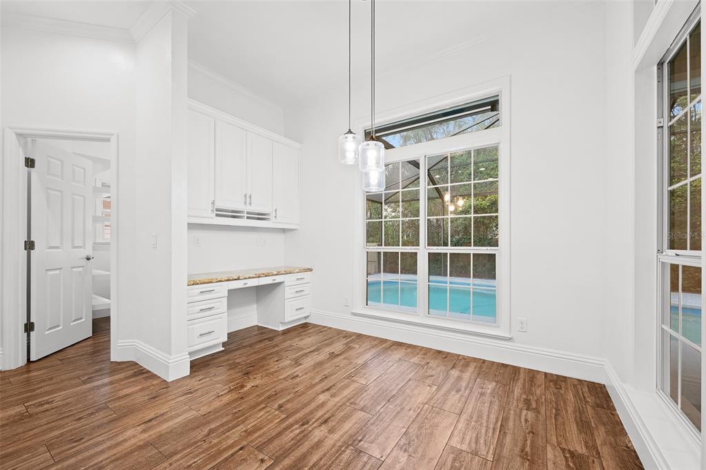 9702 Southwest 35th Lane Gainesville, FL 32608 - Photo 11 of 46 a view of a kitchen with wooden floor and a window