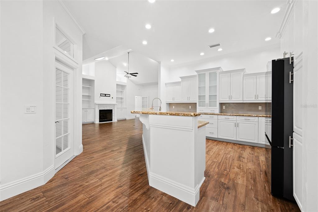 9702 Southwest 35th Lane Gainesville, FL 32608 - Photo 12 of 46 a kitchen with kitchen island wooden floors appliances and cabinets