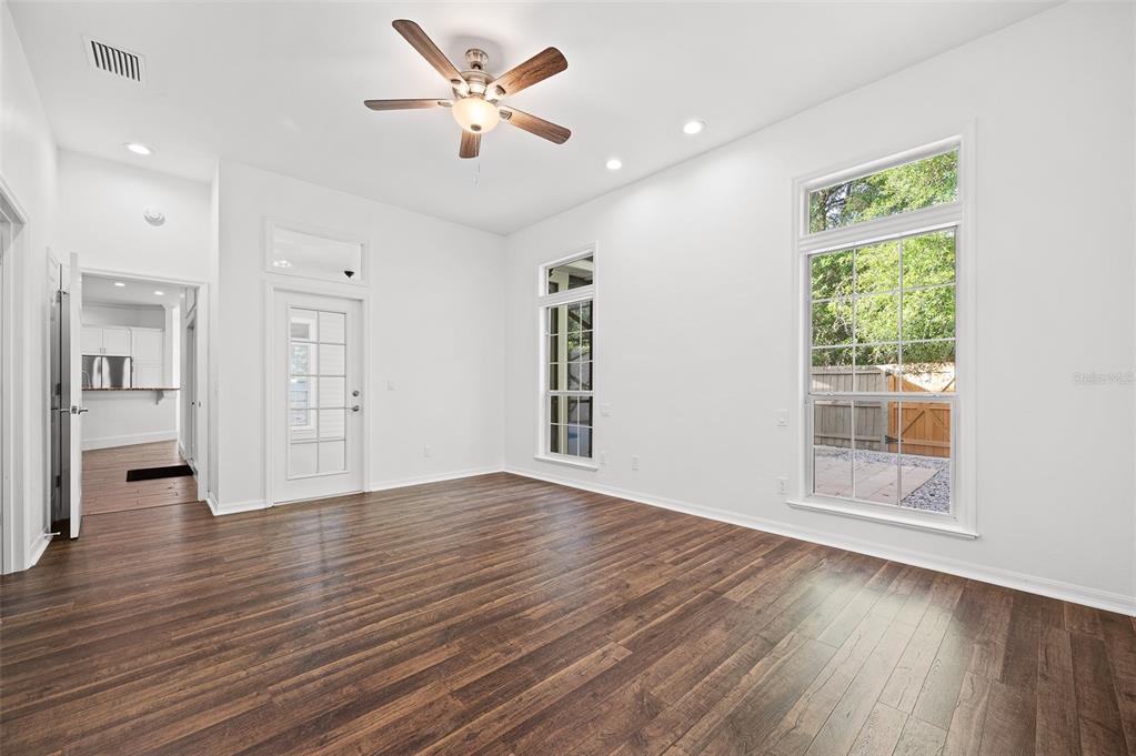 9702 Southwest 35th Lane Gainesville, FL 32608 - Photo 18 of 46 a view of an empty room with wooden floor and a window