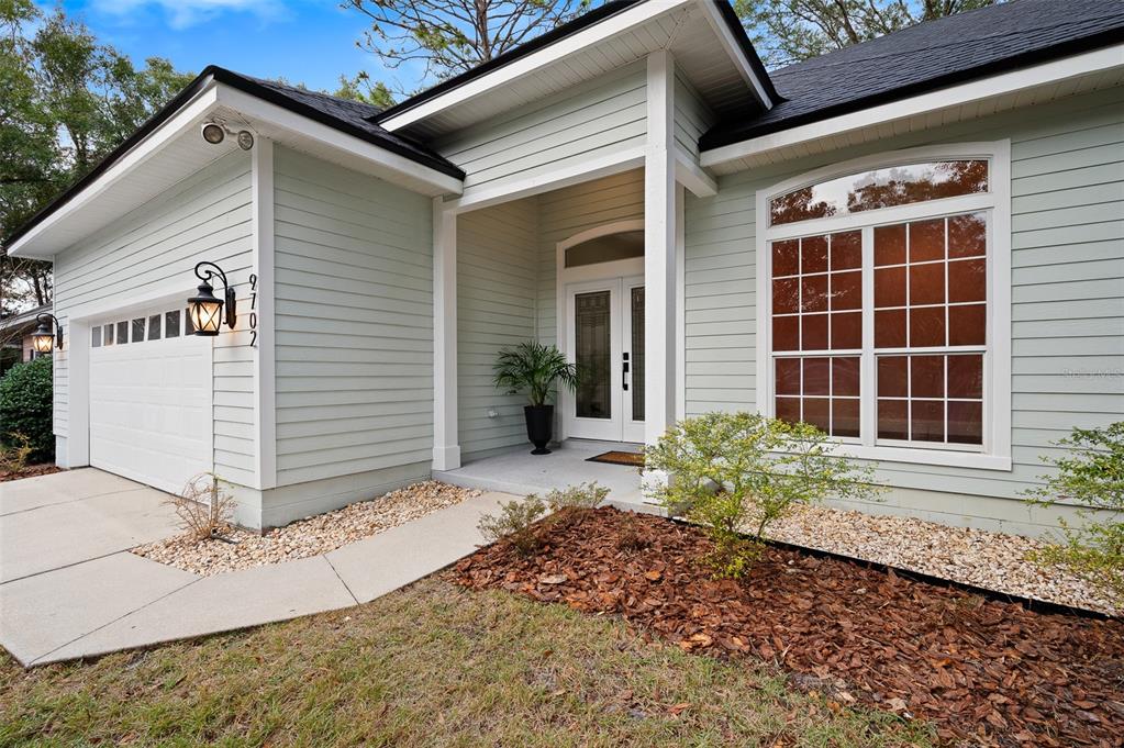 9702 Southwest 35th Lane Gainesville, FL 32608 - Photo 2 of 46 a front view of a house with a yard