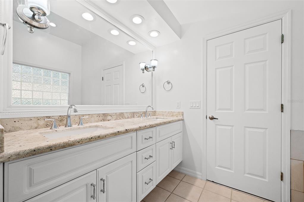 9702 Southwest 35th Lane Gainesville, FL 32608 - Photo 25 of 46 a bathroom with a granite countertop double vanity sink mirror and
