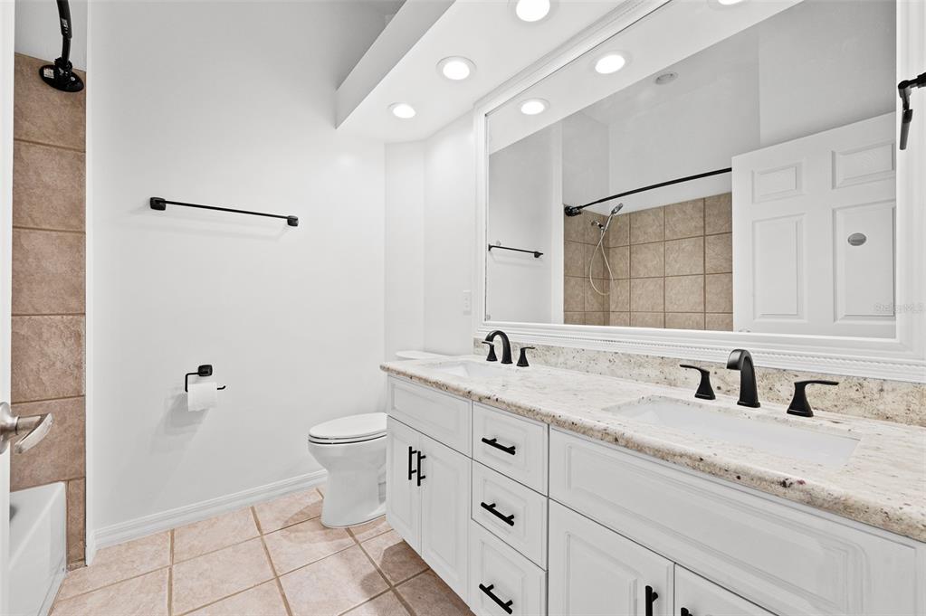 9702 Southwest 35th Lane Gainesville, FL 32608 - Photo 28 of 46 a bathroom with a double vanity sink toilet and mirror