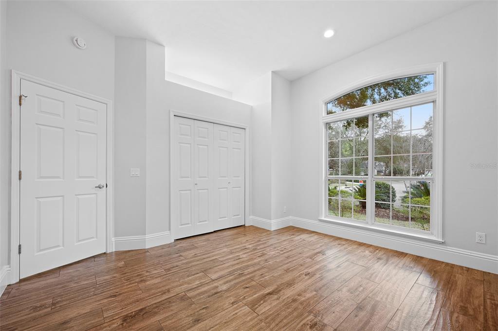 9702 Southwest 35th Lane Gainesville, FL 32608 - Photo 30 of 46 a view of an empty room with wooden floor and a window