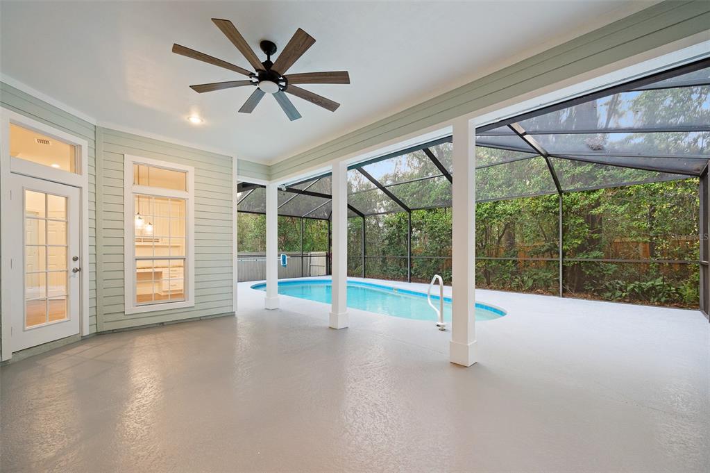 9702 Southwest 35th Lane Gainesville, FL 32608 - Photo 31 of 46 a view of empty room with wooden floor and fan