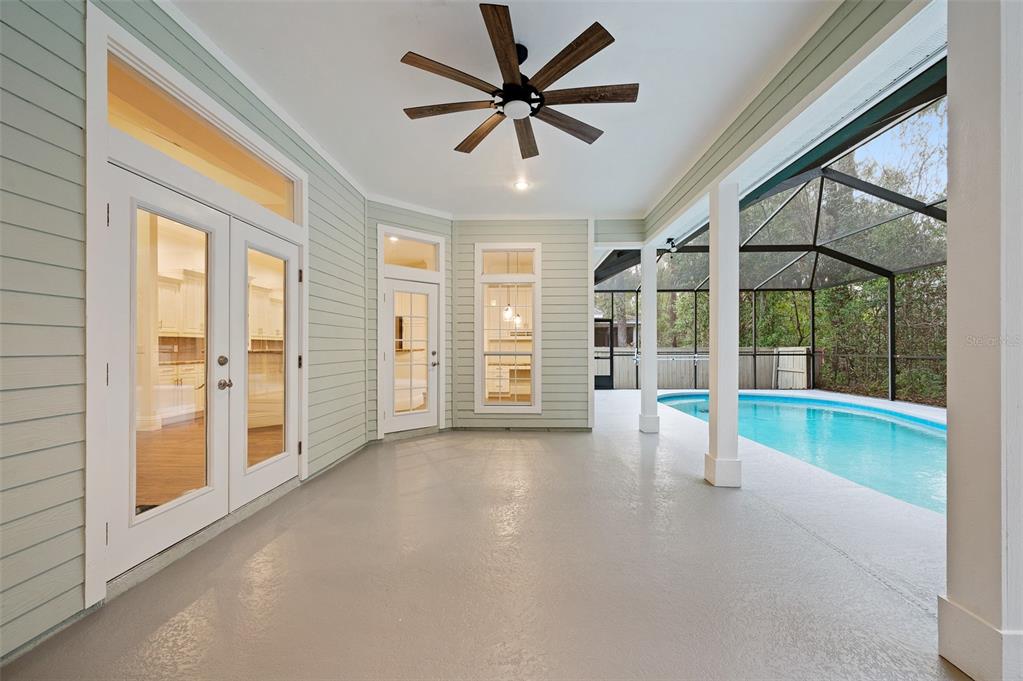 9702 Southwest 35th Lane Gainesville, FL 32608 - Photo 32 of 46 a view of empty room with wooden floor and a ceiling fan