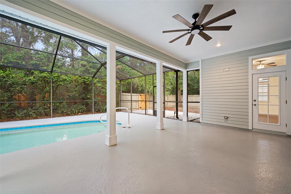 9702 Southwest 35th Lane Gainesville, FL 32608 - Photo 33 of 46 a view of empty room with floor to ceiling window and ceiling fan