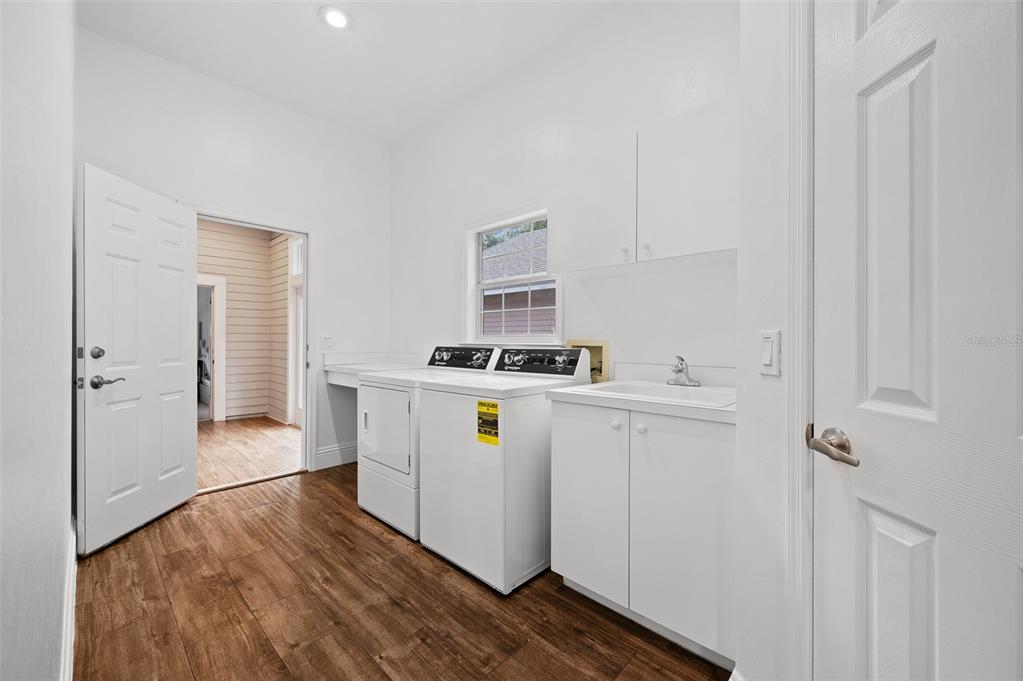 9702 Southwest 35th Lane Gainesville, FL 32608 - Photo 41 of 46 a utility room with cabinets washer and dryer