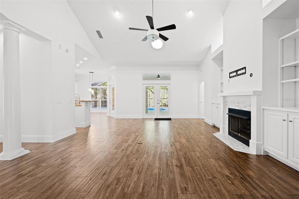 9702 Southwest 35th Lane Gainesville, FL 32608 - Photo 6 of 46 a view of an empty room with a fireplace and wooden floor
