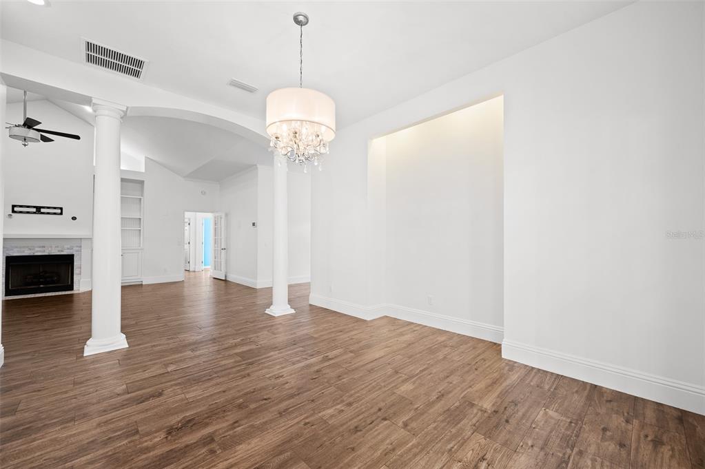 9702 Southwest 35th Lane Gainesville, FL 32608 - Photo 8 of 46 a view of a room with wooden floor and chandelier