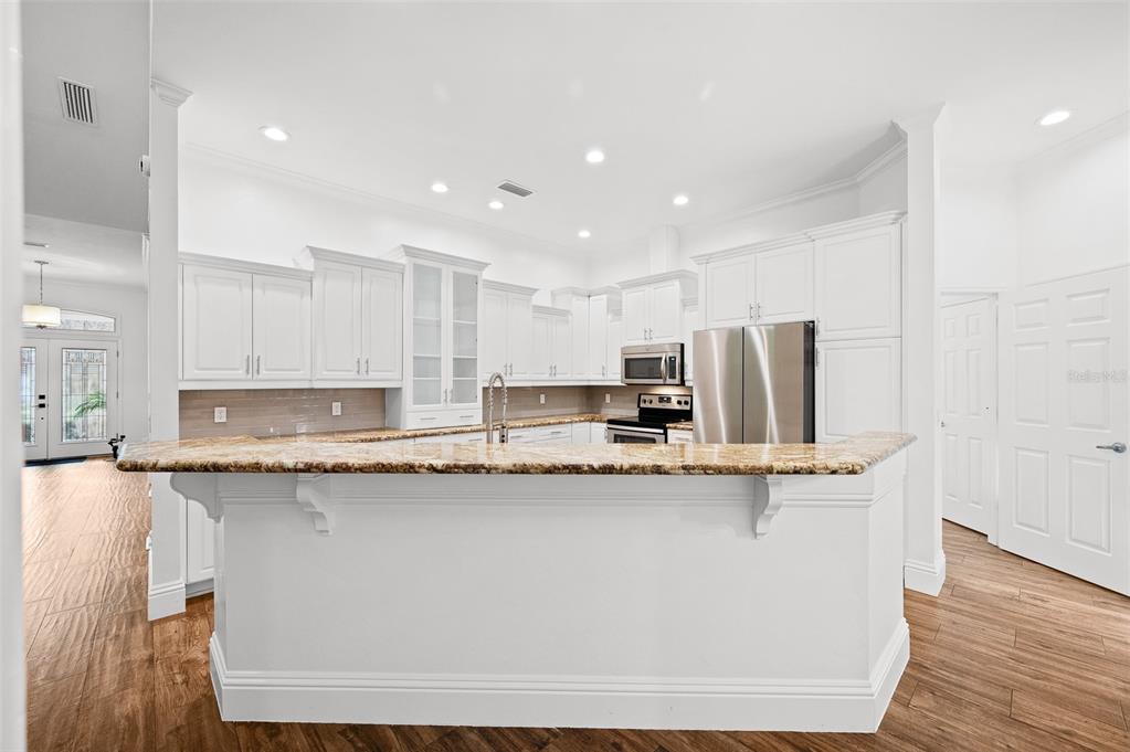 9702 Southwest 35th Lane Gainesville, FL 32608 - Photo 10 of 46 a kitchen with stainless steel appliances granite countertop a sink a stove and a refrigerator