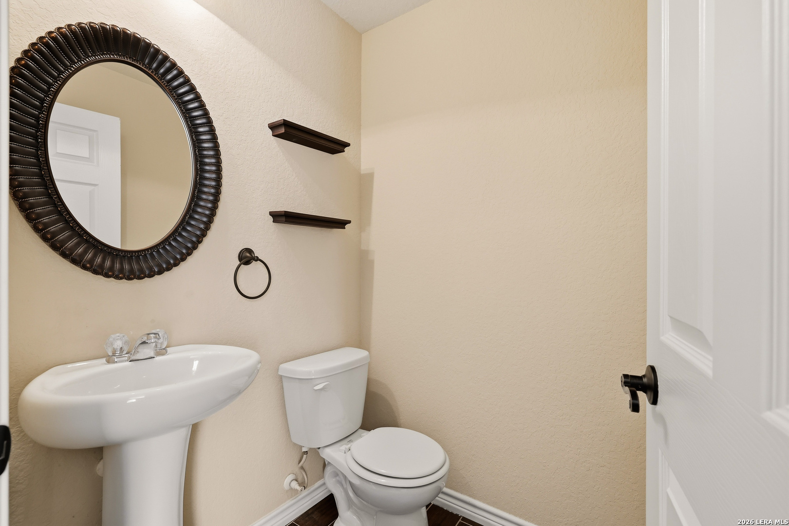 11839 Dove Ranch San Antonio, TX 78254 - Photo 16 of 35 a bathroom with a sink mirror and toilet