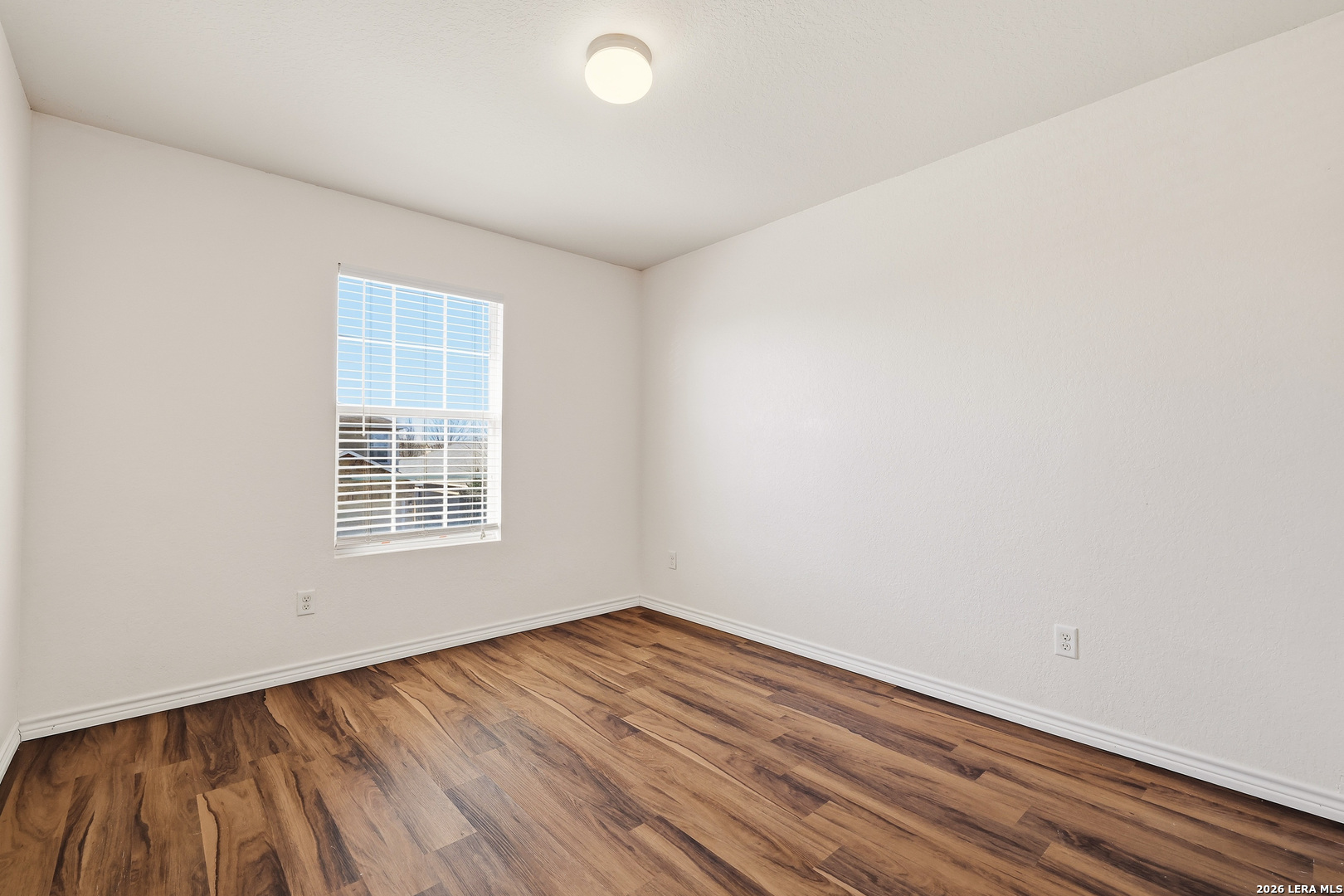 11839 Dove Ranch San Antonio, TX 78254 - Photo 26 of 35 an empty room with wooden floor and windows