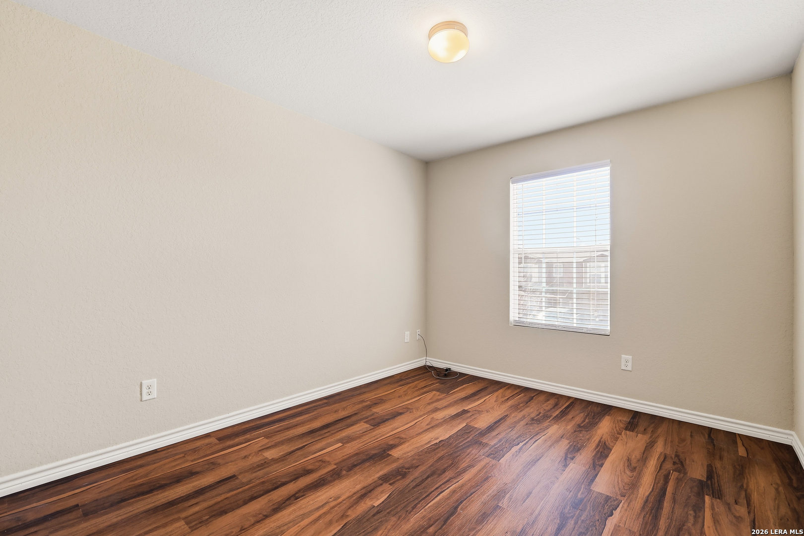 11839 Dove Ranch San Antonio, TX 78254 - Photo 29 of 35 an empty room with wooden floor and windows