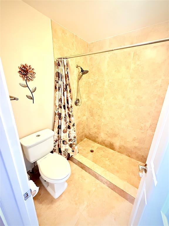 3117 Kingswood Terrace, Unit 3117 Boca Raton, FL 33431 - Photo 3 of 15 a bathroom with a sink a toilet and shower
