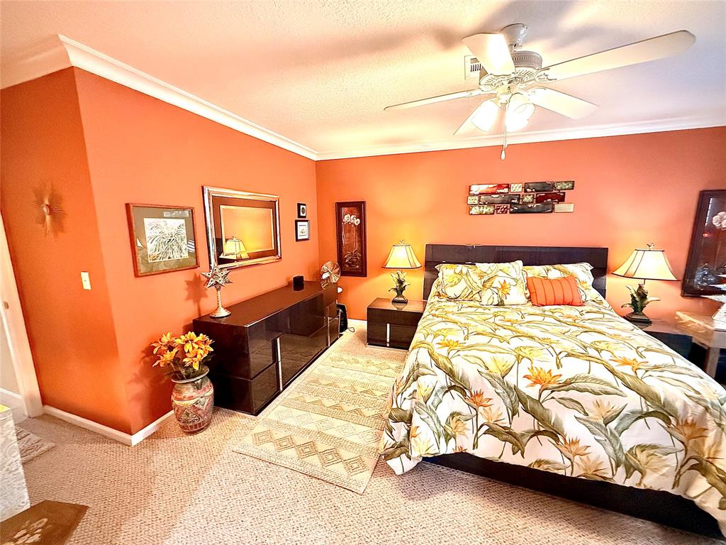 3117 Kingswood Terrace, Unit 3117 Boca Raton, FL 33431 - Photo 5 of 15 a bedroom with a bed and a chandelier