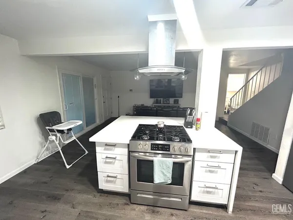 a stove top oven sitting inside of a kitchen