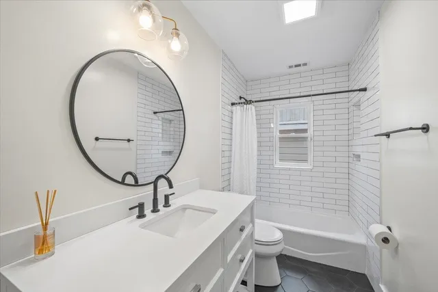 a bathroom with a bathtub and shower