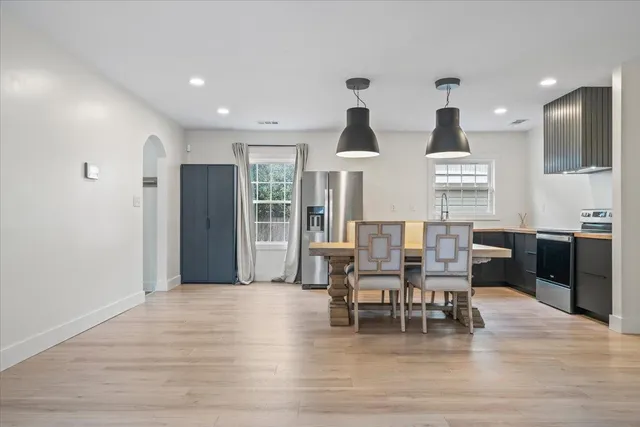 a view of a dining room with furniture and wooden floor