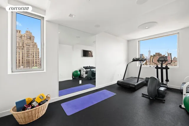 a room with gym equipment and a view of living room