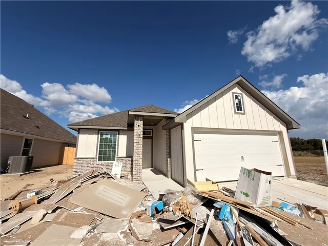 a view of a house with wooden deck and furniture