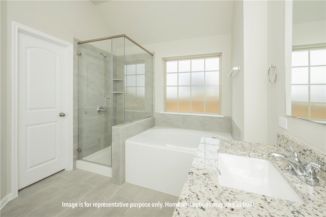 6049 Badger Street Bryan, TX 77807 - Photo 11 of 16 a bathroom with a tub a sink and a shower