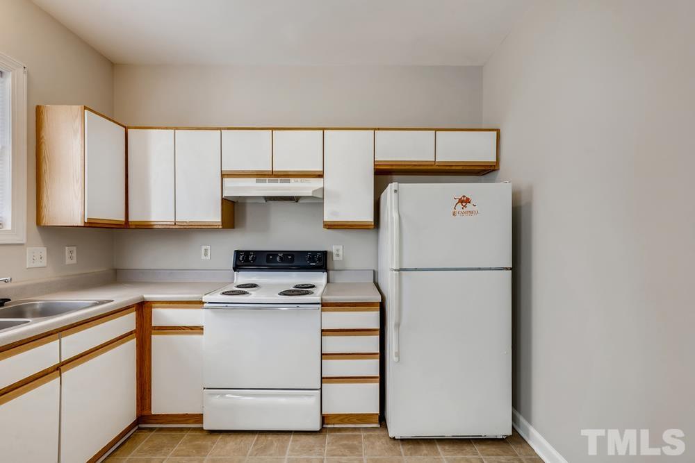 2336 Milburnie Road Raleigh, NC 27610 - Photo 12 of 28 a white refrigerator freezer sitting inside of a kitchen