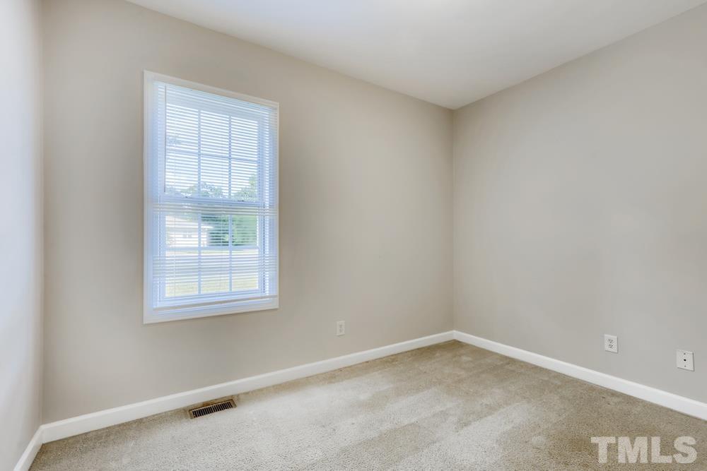 2336 Milburnie Road Raleigh, NC 27610 - Photo 20 of 28 an empty room with a window