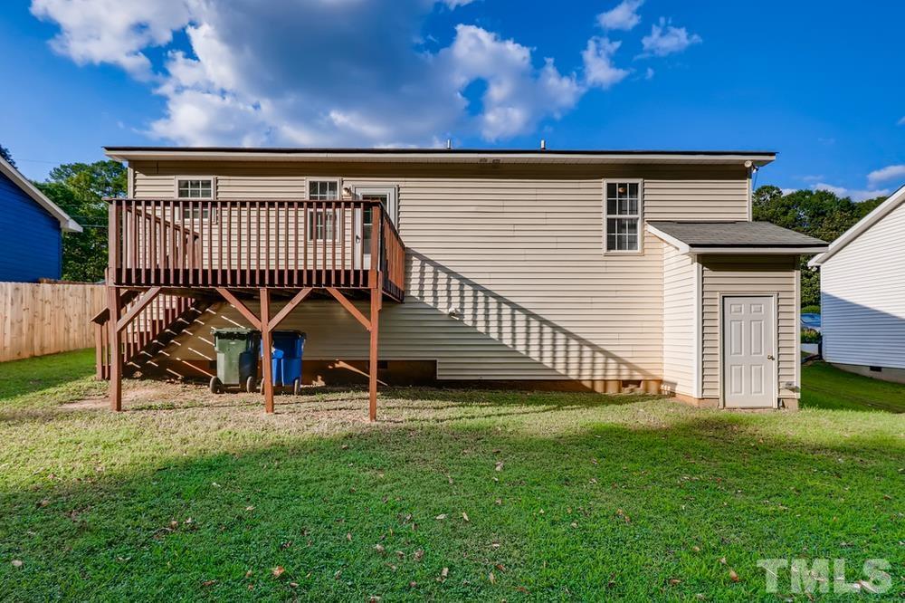 2336 Milburnie Road Raleigh, NC 27610 - Photo 26 of 28 a backyard of a house with table and chairs
