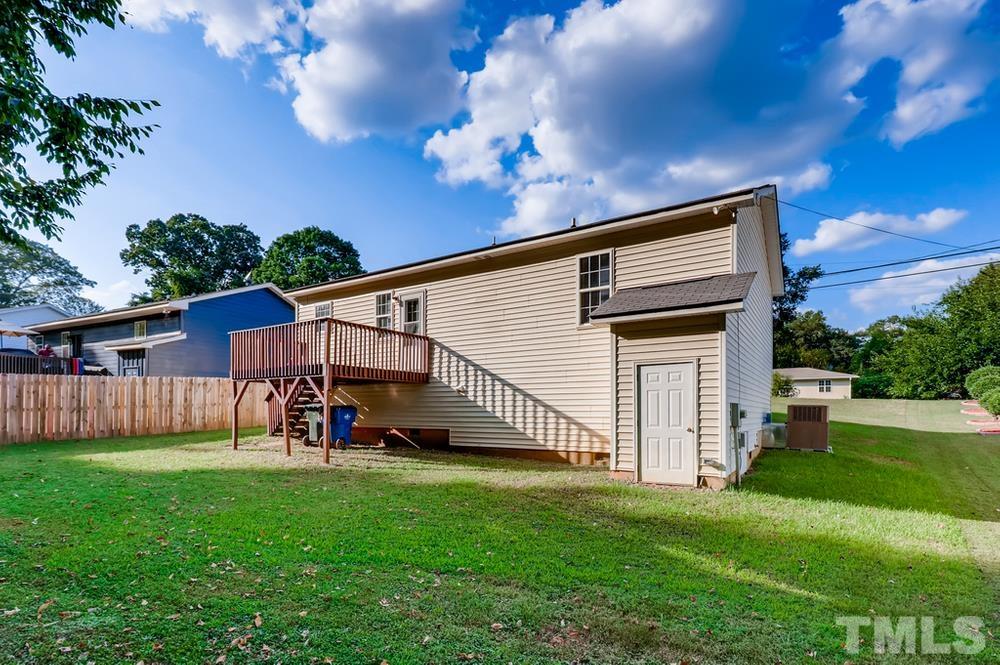 2336 Milburnie Road Raleigh, NC 27610 - Photo 27 of 28 a view of backyard with a garden and deck