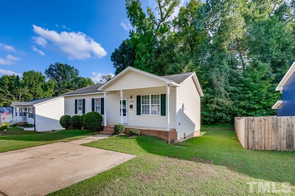 2336 Milburnie Road Raleigh, NC 27610 - Photo 28 of 28 a view of a yard in front of a house with plants and large tree