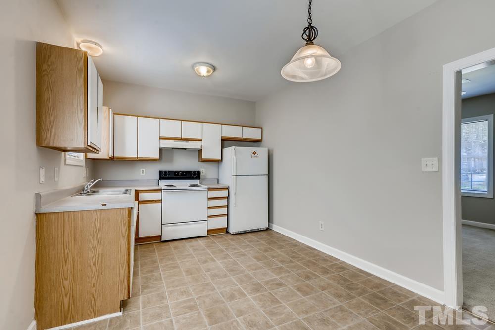 2336 Milburnie Road Raleigh, NC 27610 - Photo 10 of 28 a kitchen with stainless steel appliances granite countertop a stove a sink and a refrigerator