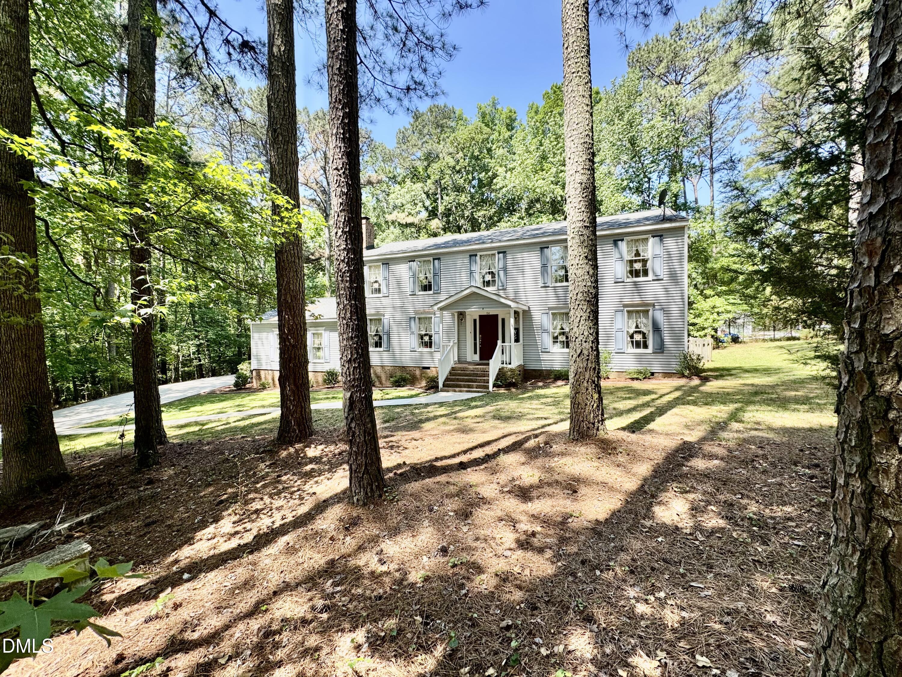 84 Wintergreen Road Henderson, NC 27537 - Photo 3 of 49 a view of a house with backyard and a tree