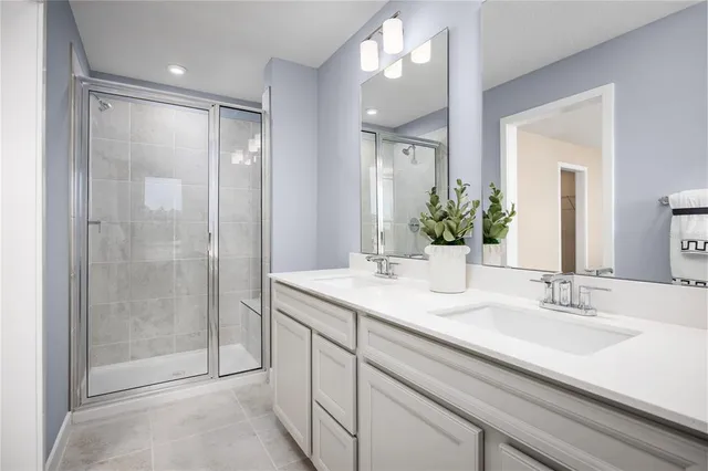 a bathroom with a shower sink and mirror