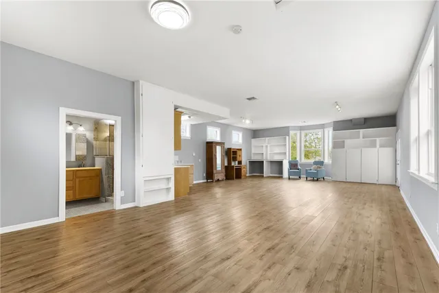 a view of a livingroom with furniture hardwood floor and staircase
