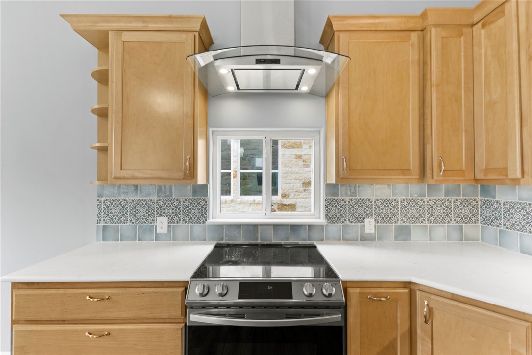 504 North Street Columbus, TX 78934 - Photo 7 of 29 Kitchen featuring stainless steel electric range, light countertops, island exhaust hood, open shelves, and light brown cabinets