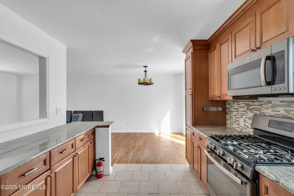a kitchen with stainless steel appliances granite countertop a stove and a sink