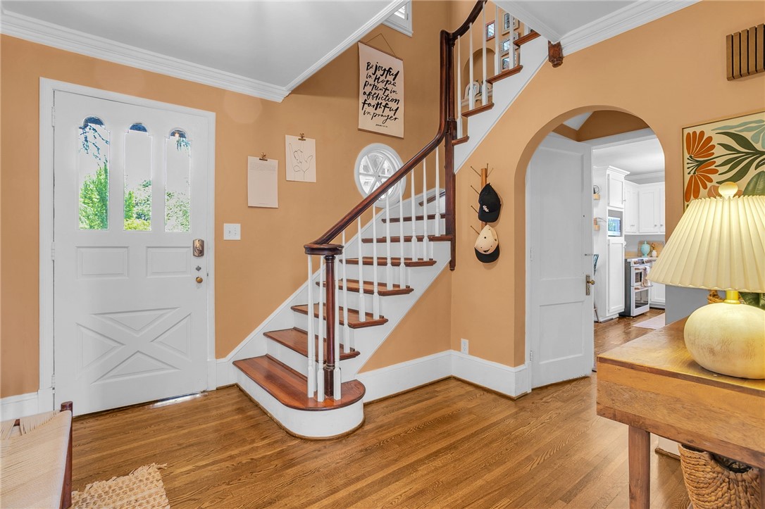 1107 Springdale Road Anderson, SC 29621 - Photo 5 of 49 Enter into a charming foyer featuring a gracefully curved staircase and gleaming hardwood floors.