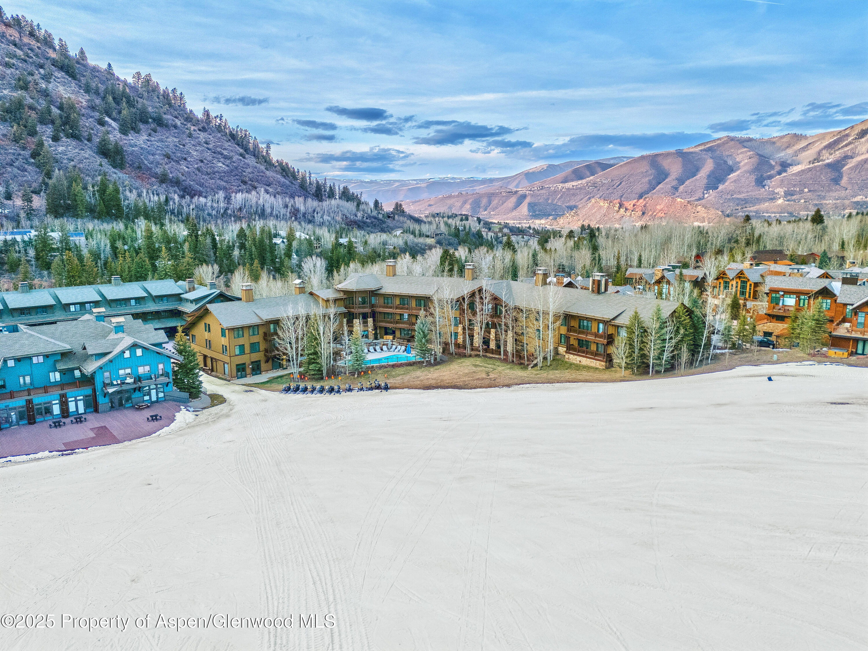 133 Prospector Road, Unit 2410 FW 3 26 33 & FLOAT Aspen, CO 81611 - Photo 1 of 12 a view of a street with a cars parked in front of it