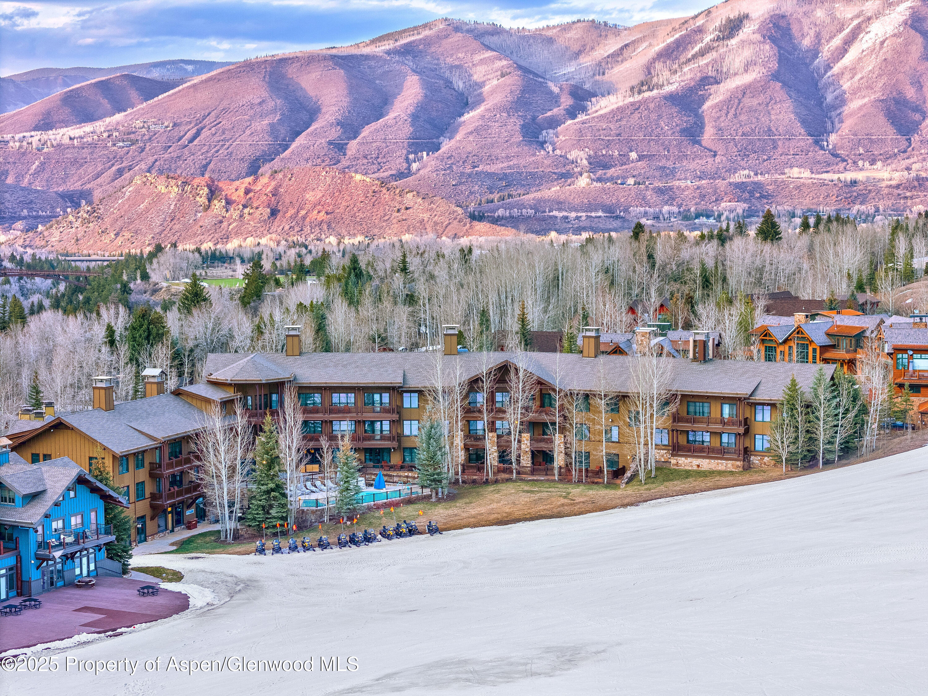 133 Prospector Road, Unit 2410 FW 3 26 33 & FLOAT Aspen, CO 81611 - Photo 2 of 12 a front view of a building with a yard