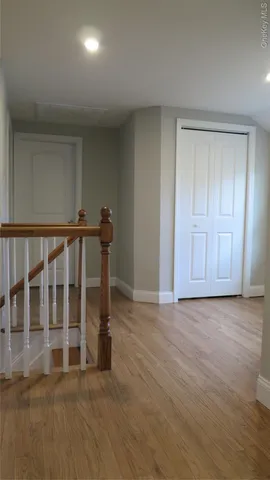 a view of wooden floor and windows in a room