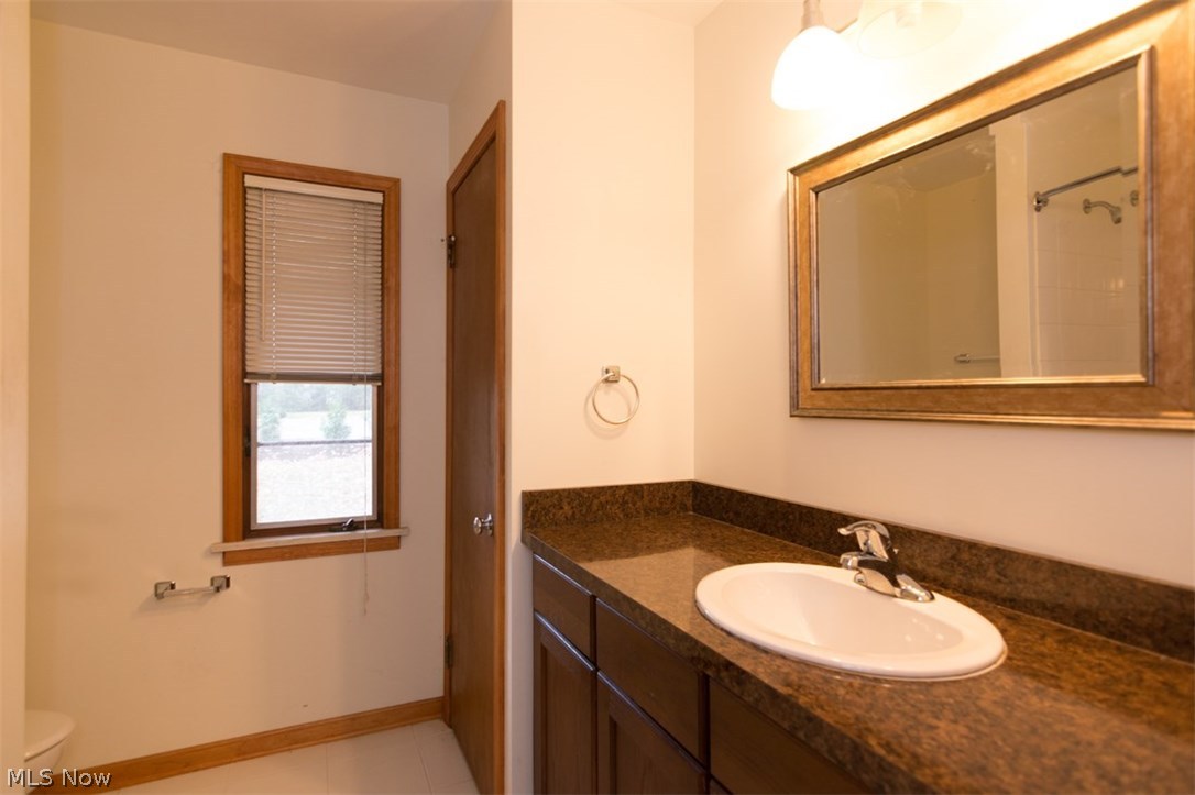 30200 Smithfield Road Chagrin Falls, OH 44022 - Photo 19 of 27 The hall bathroom is spacious with an extra-wide vanity area and a linen closet.