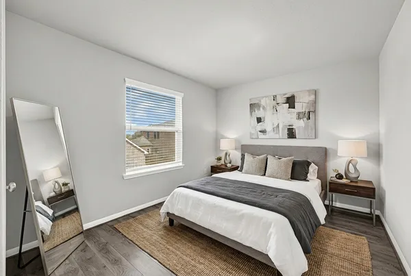 a bedroom with a bed and a window