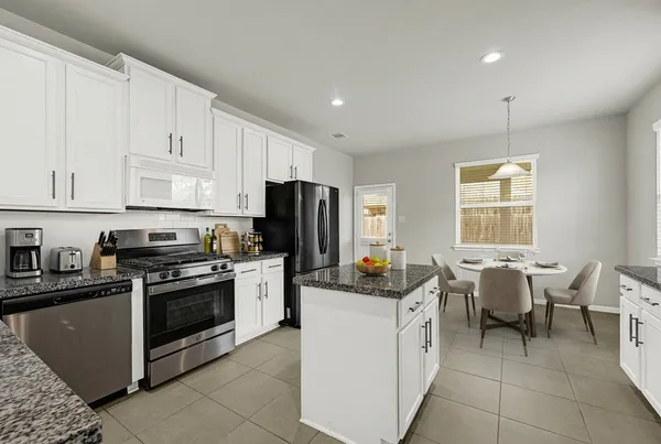 a kitchen with a stove a sink and a refrigerator