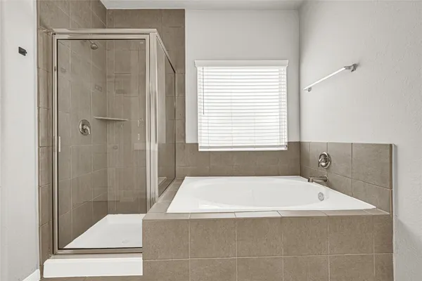 a bathroom with a bathtub and shower