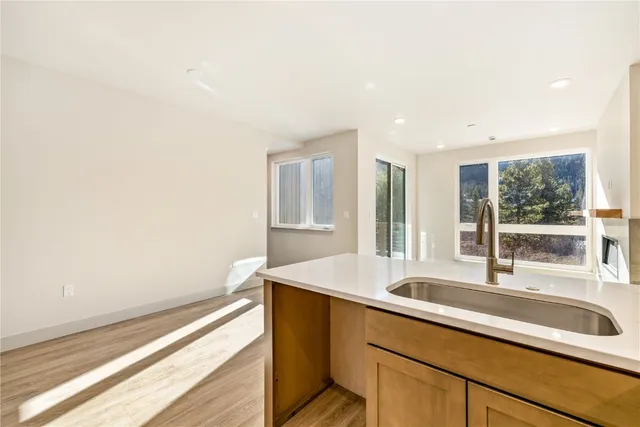 a kitchen with a sink and large window