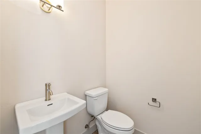 a white toilet sitting next to a white sink
