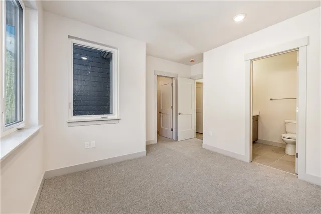 a view of empty room with a bathroom