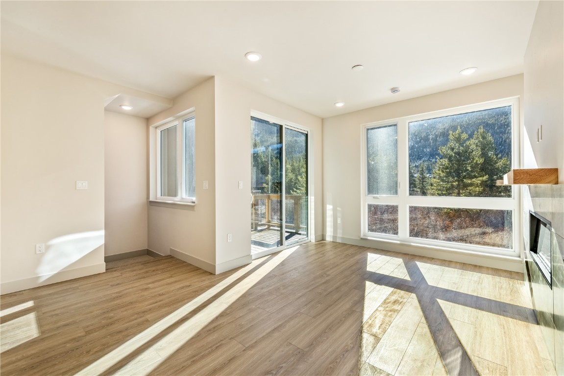 632 Montezuma Road, Unit C2 Keystone, CO 80435 - Photo 7 of 40 a view of an empty room with wooden floor and a window
