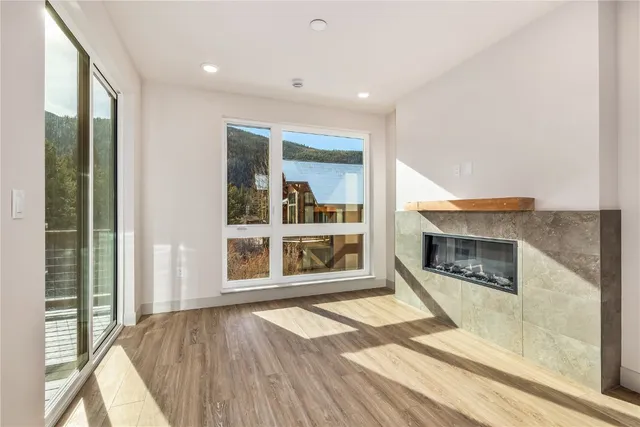 a view of an empty room with a fireplace and a window