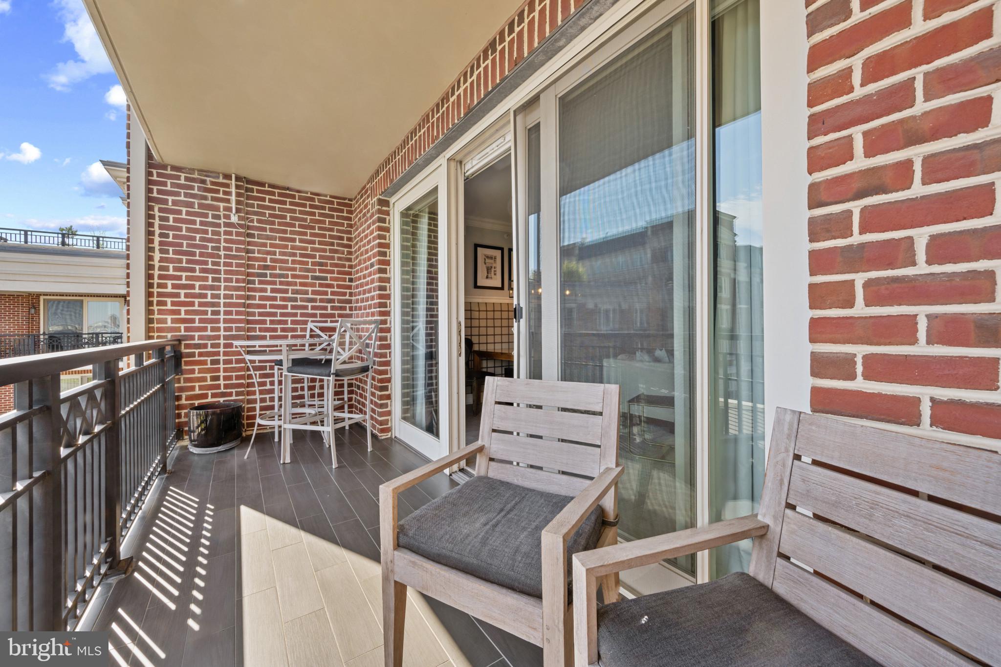 801 Key Highway, Unit 458 Baltimore, MD 21230 - Photo 11 of 48 a backyard of a house with barbeque oven table and chairs